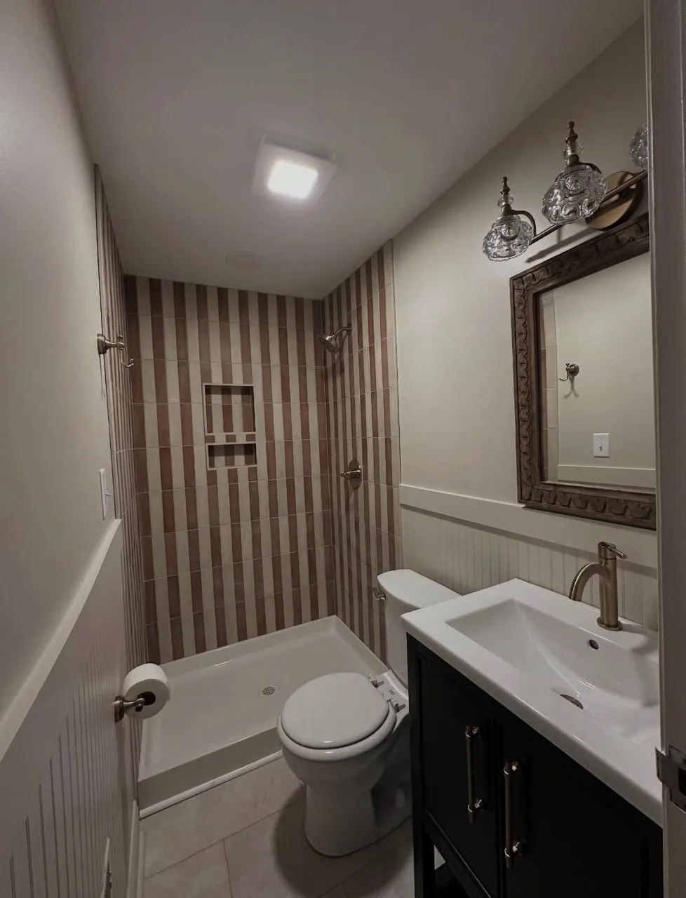 A Greenville, NC bathroom remodel that has been done by Lee Brothers Construction that includes a new shower installation, new sink and mirror