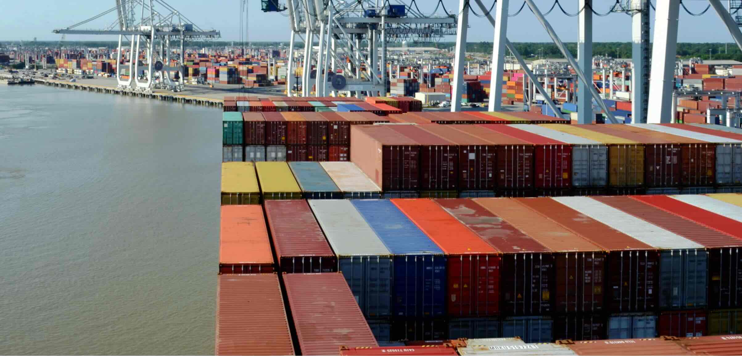 A view of a busy shipping port with colorful stacked cargo containers