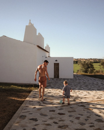 Adulte et enfant devant une maison blanche de Montinhos, maison d'hôtes en Alentejo, Portugal