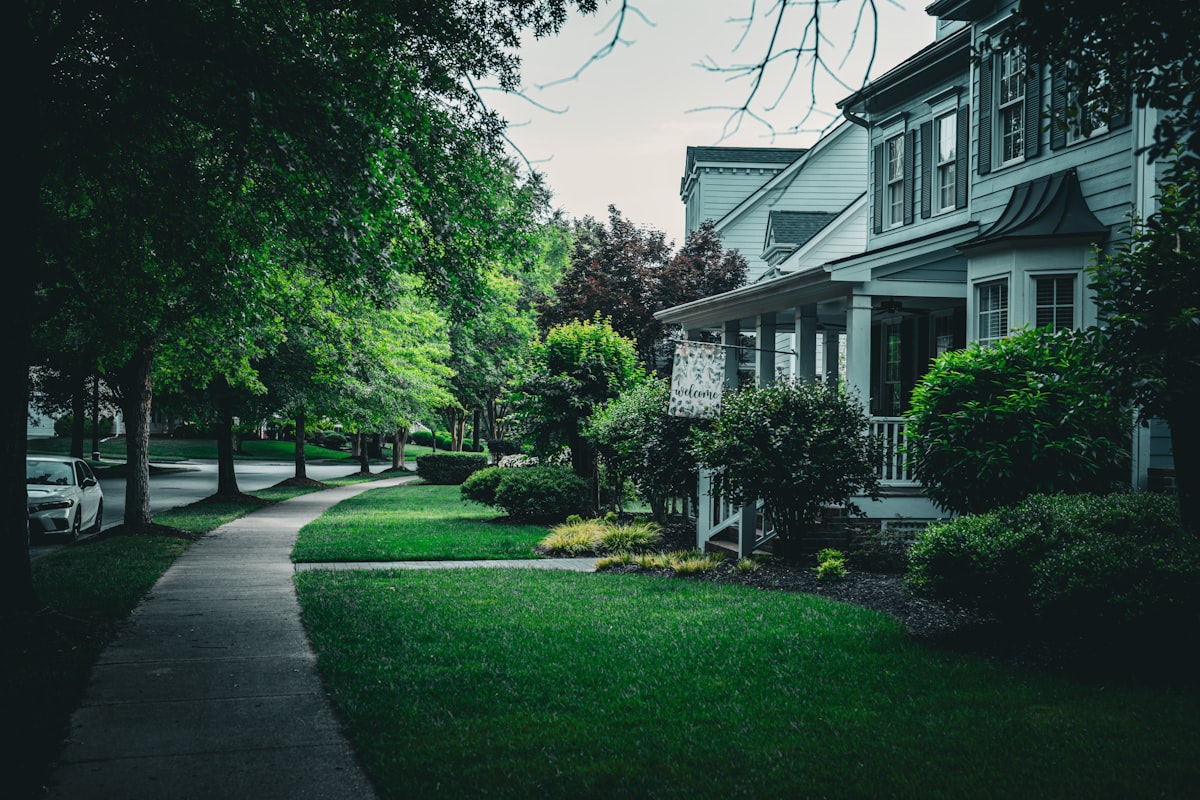 Beautiful house with a green lawn and sidewalk showcasing front yard curb appeal