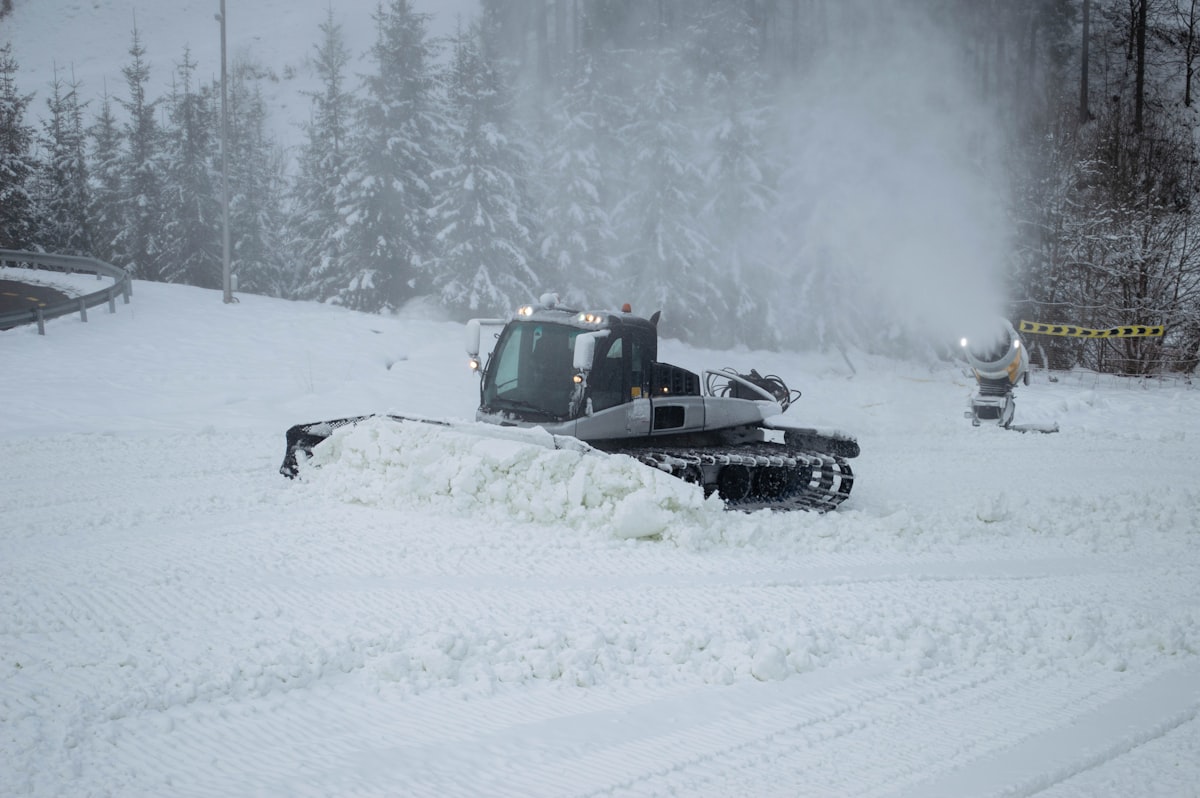 Snow plow clearing a road during winter snowfall