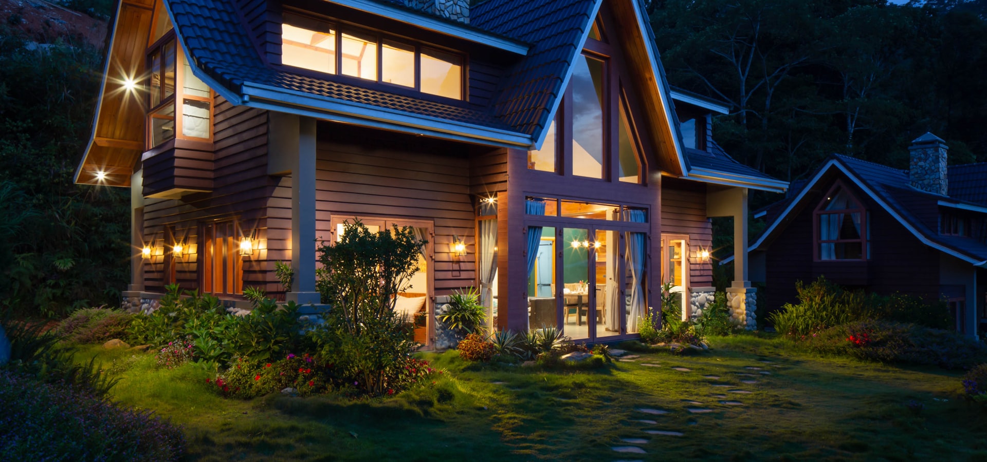 Custom estate home with landscape lighting at dusk in Great Falls, Virginia