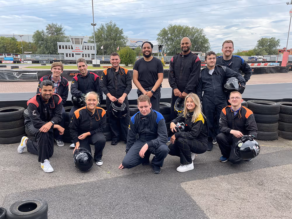 A group of people in racing tracksuits.
