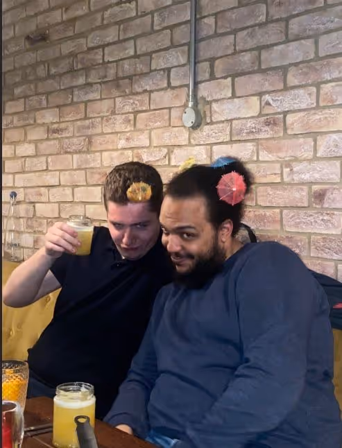 Two men smiling