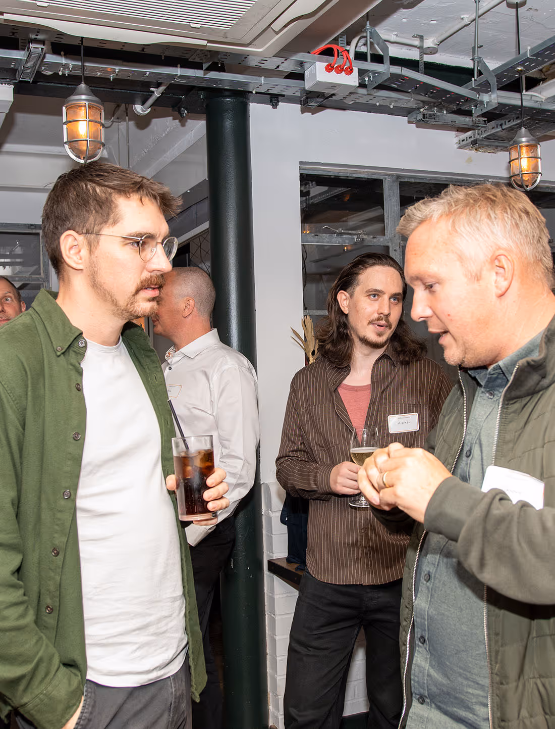 Three men having drinks.