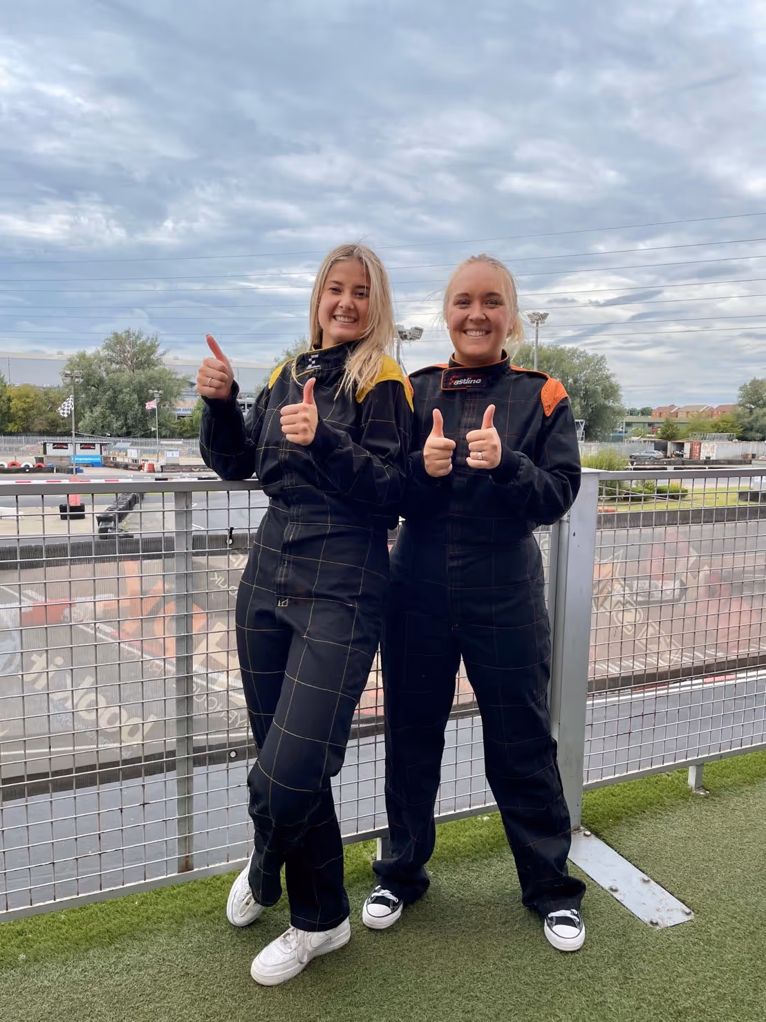 Two people in racing suits.