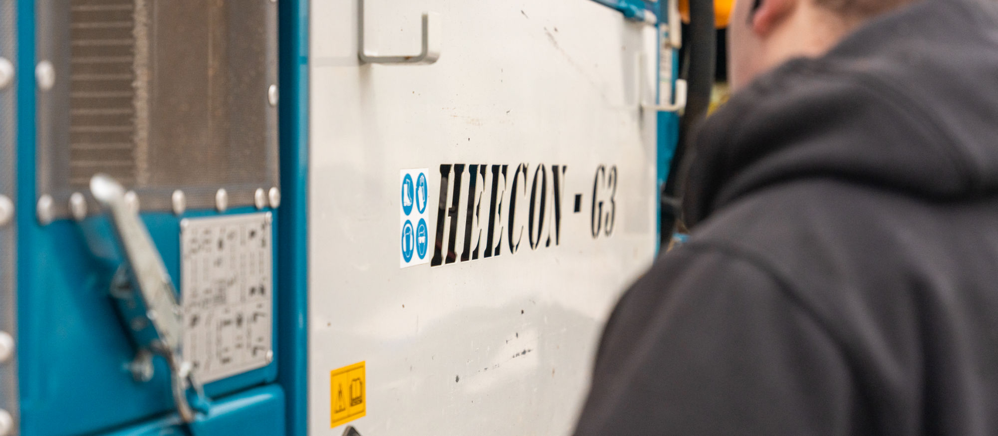 Medewerker van Heecon bedient een machine