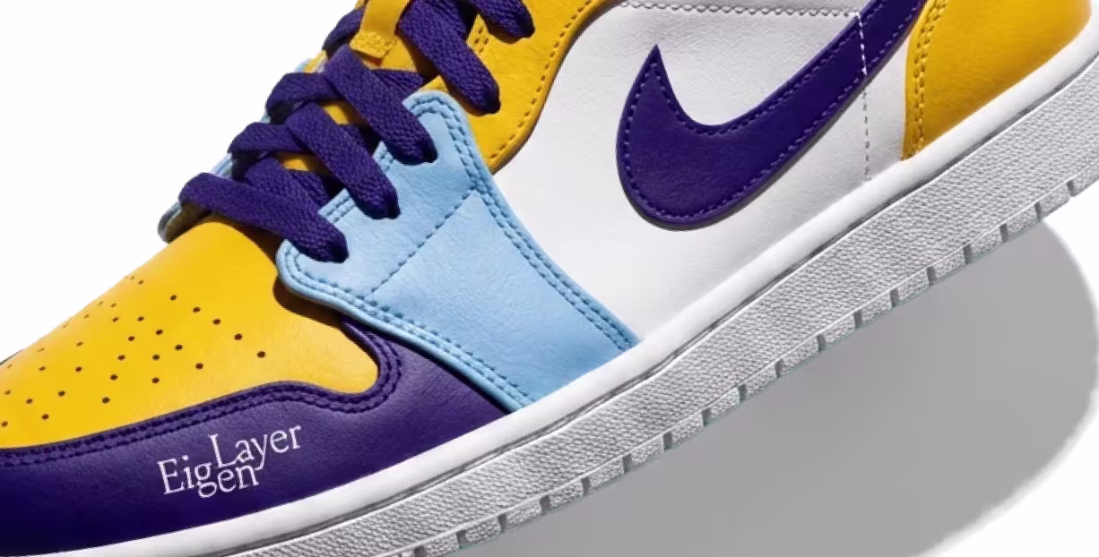 Close-up of a yellow, purple, light blue, and white sneaker with purple laces and a purple Nike swoosh.