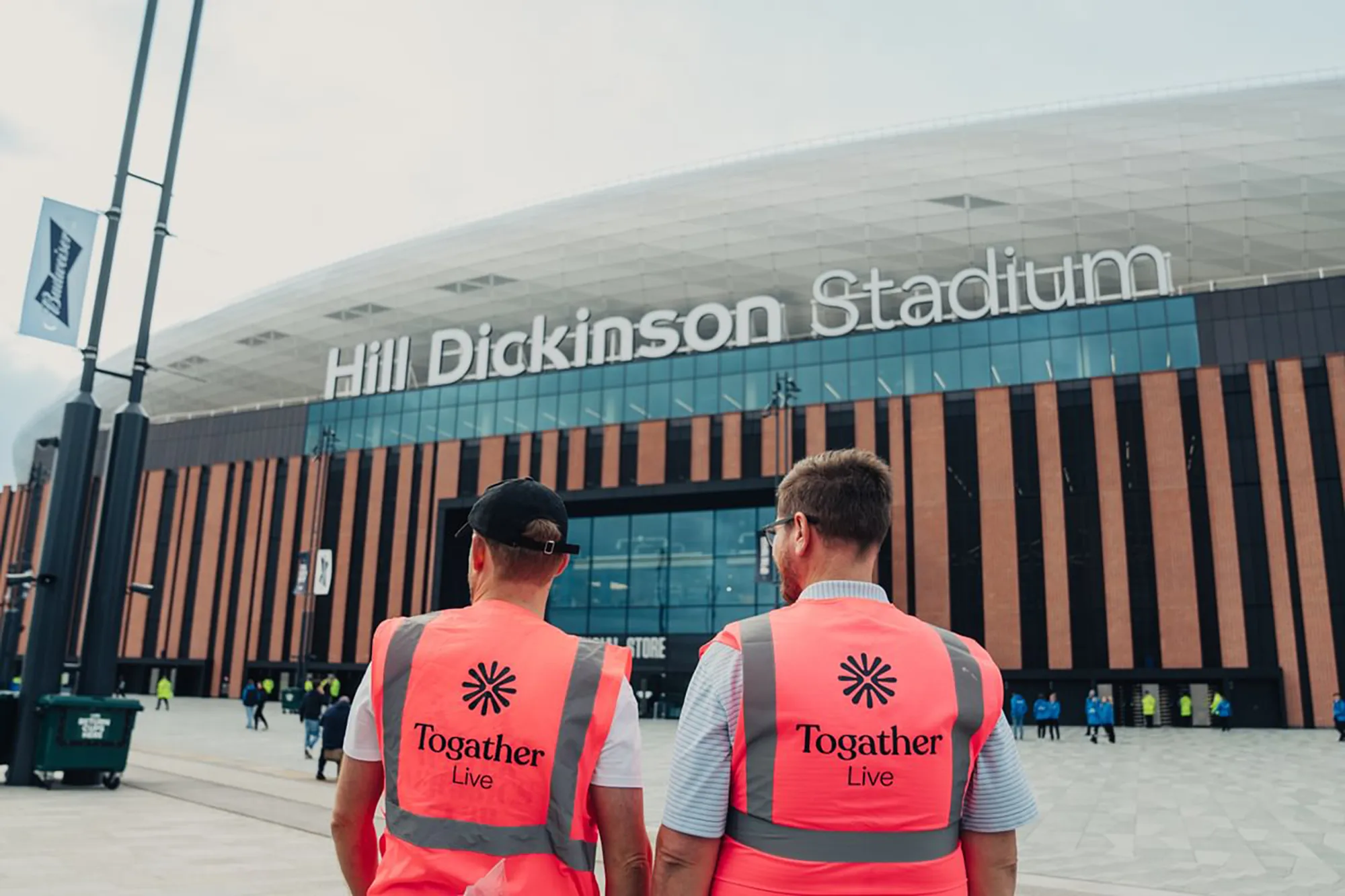Togather employees in branded hi-vis outside the Hill Dickinson stadium 