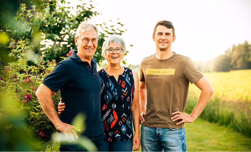 Die Familie Elsner steht auf einem Feld und lacht in die Kamera