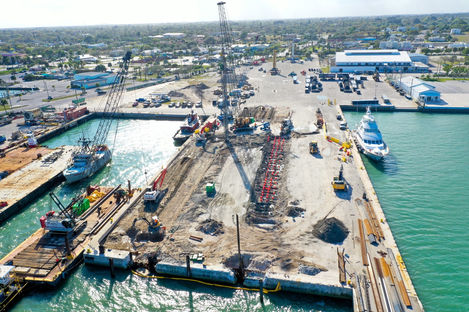 Aerial view of Fort Pierce Port with marine construction activity, cranes and vessels