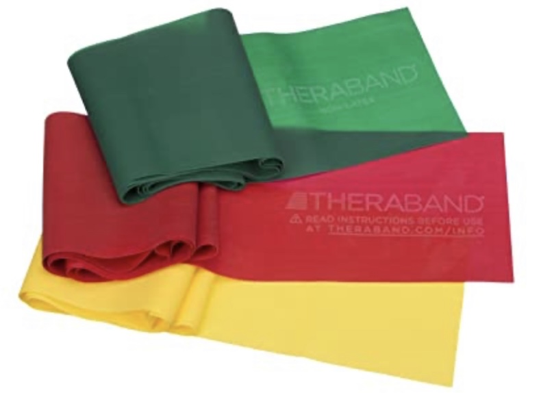 Three Theraband resistance exercise bands in green, red, and yellow