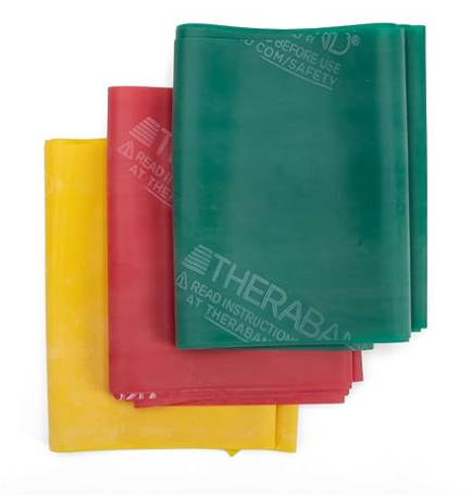 Three Theraband resistance exercise bands in yellow, red, and green