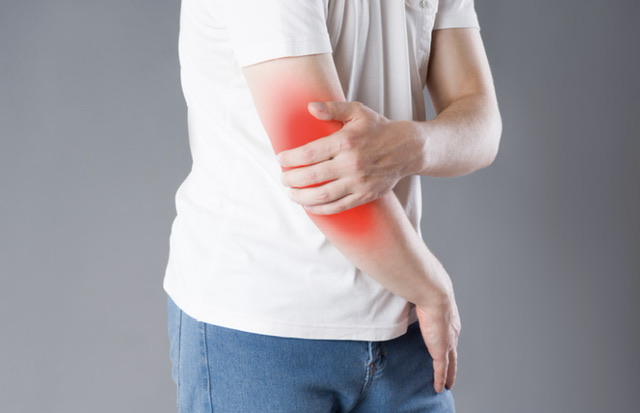 Person experiencing arm pain with red highlight indicating inflammation
