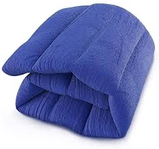 Soft blue folded blanket or comforter on white background