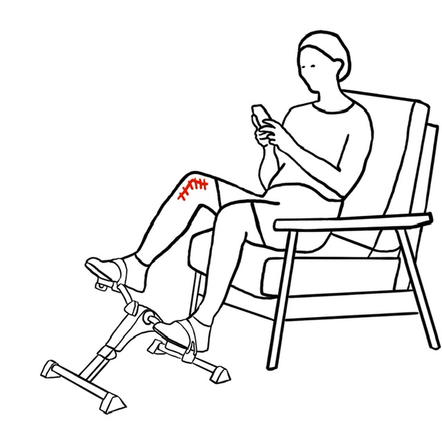 Person using mobile phone while exercising with leg pedal machine