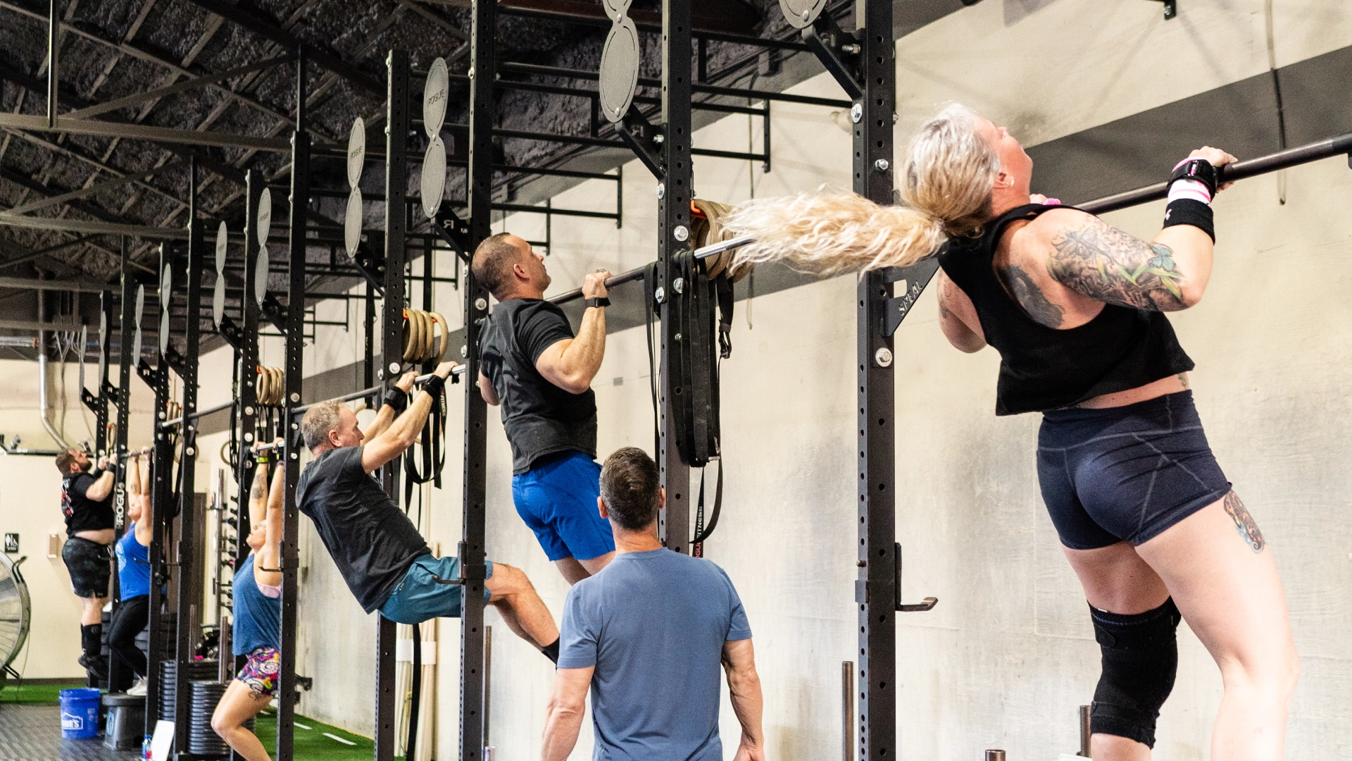 Strength & Conditioning gym interior at TriPower Strength & Conditioning in Eustis, FL, showcasing workout equipment and athletes in action.