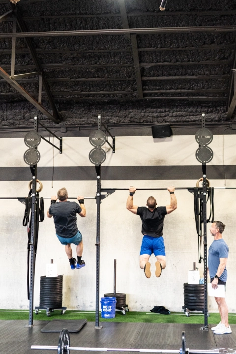 Interior view of TriPower Strength & Conditioning, a Strength & Conditioning gym in Eustis, FL, with members participating in workouts.