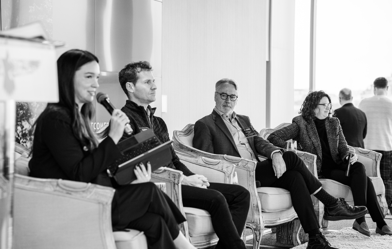 Four people standing outdoors in winter jackets, posing in front of bare trees and snow during golden hour. A white logo for Raven Indigenous Outcomes Funds appears in the top right corner. The text 'Raven Reflections' is written at the bottom.
