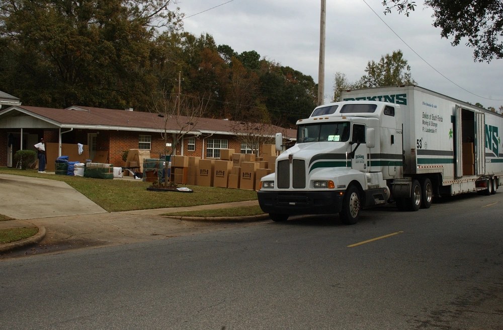 A moving truck is unloaded as a military family moves into new base housing