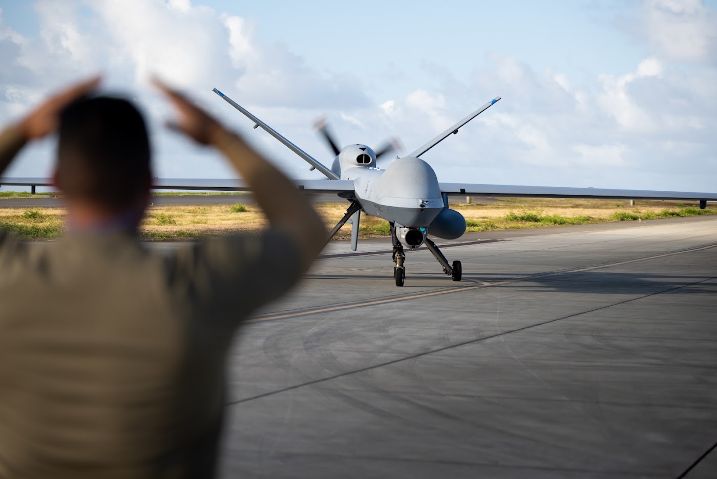Airman marshalling an aircraft on the flight line