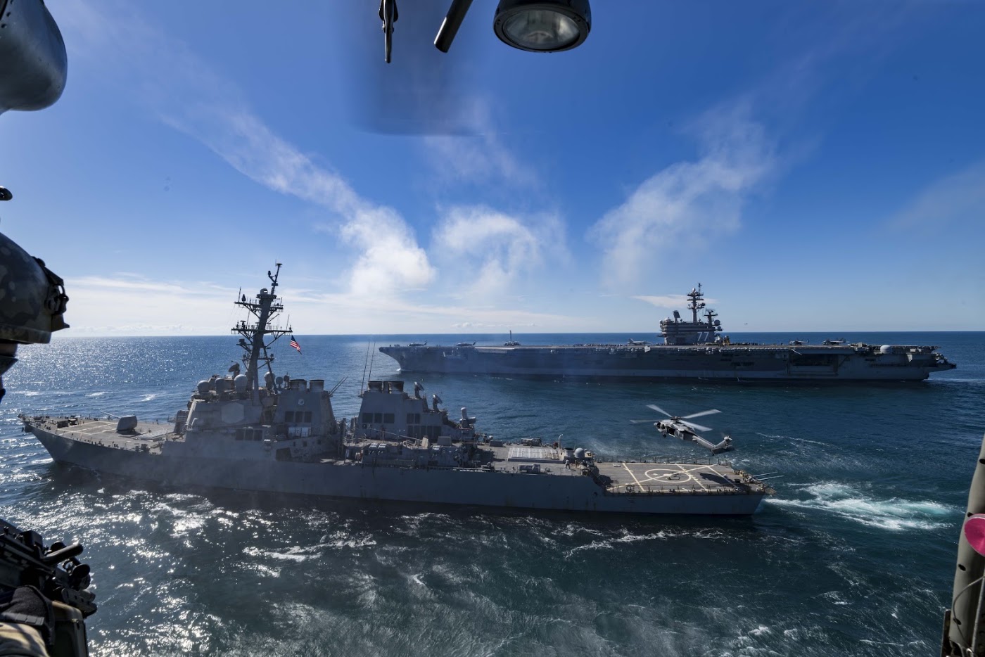 Aircraft carrier and destroyer underway at sea