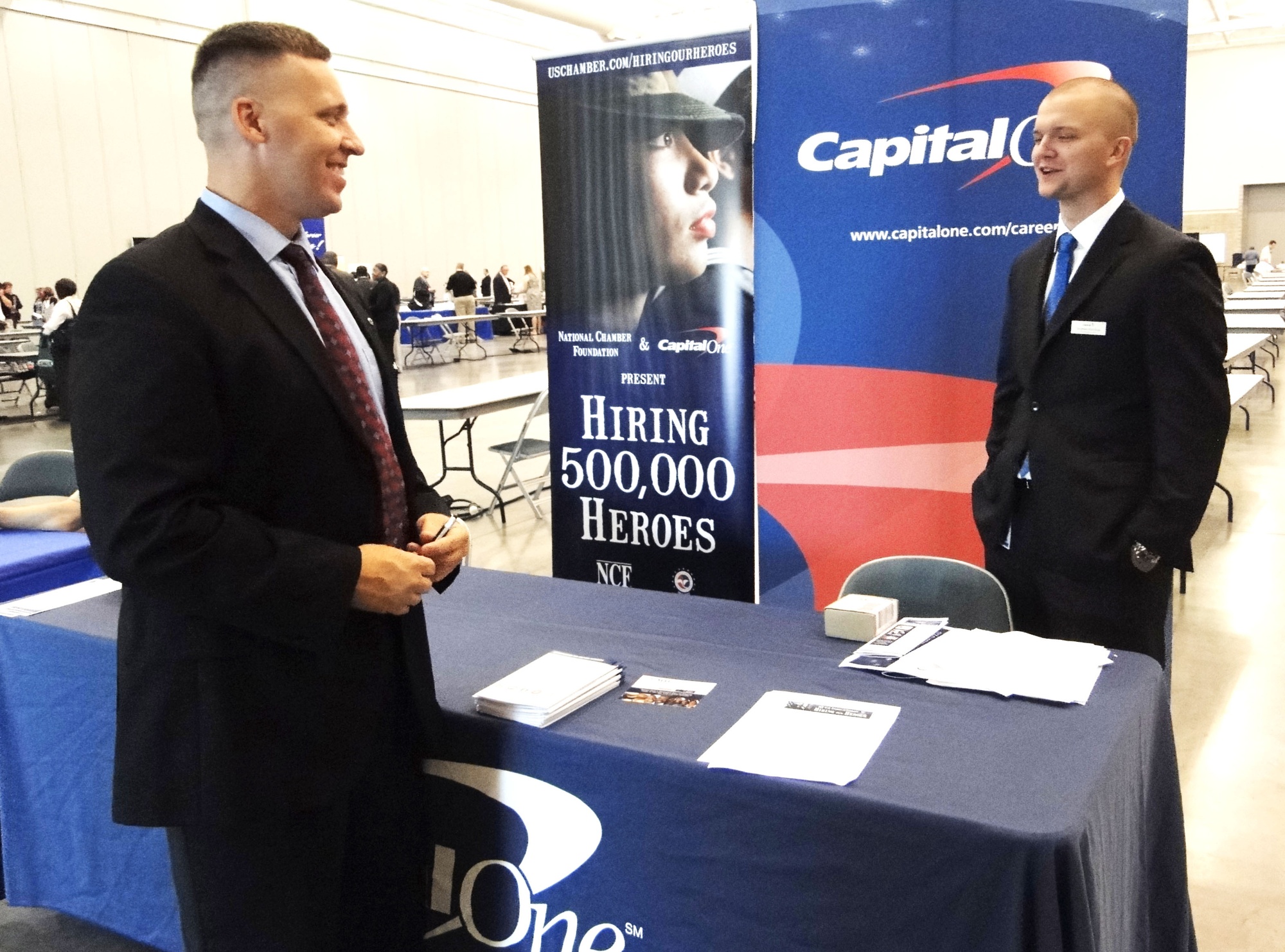 Recently separated veterans staff a booth at a military hiring fair
