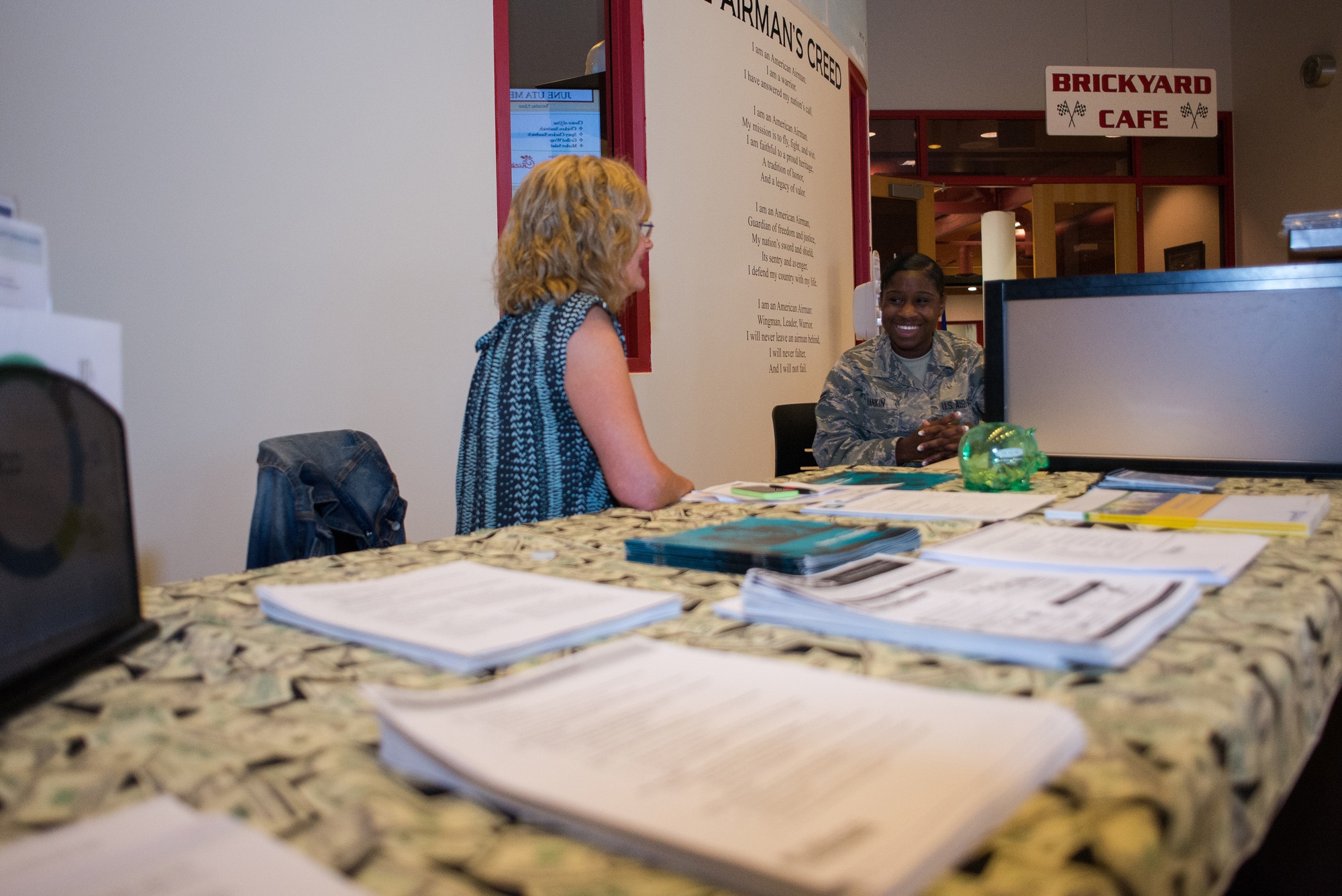 A personal financial counselor reviews finances with a service member