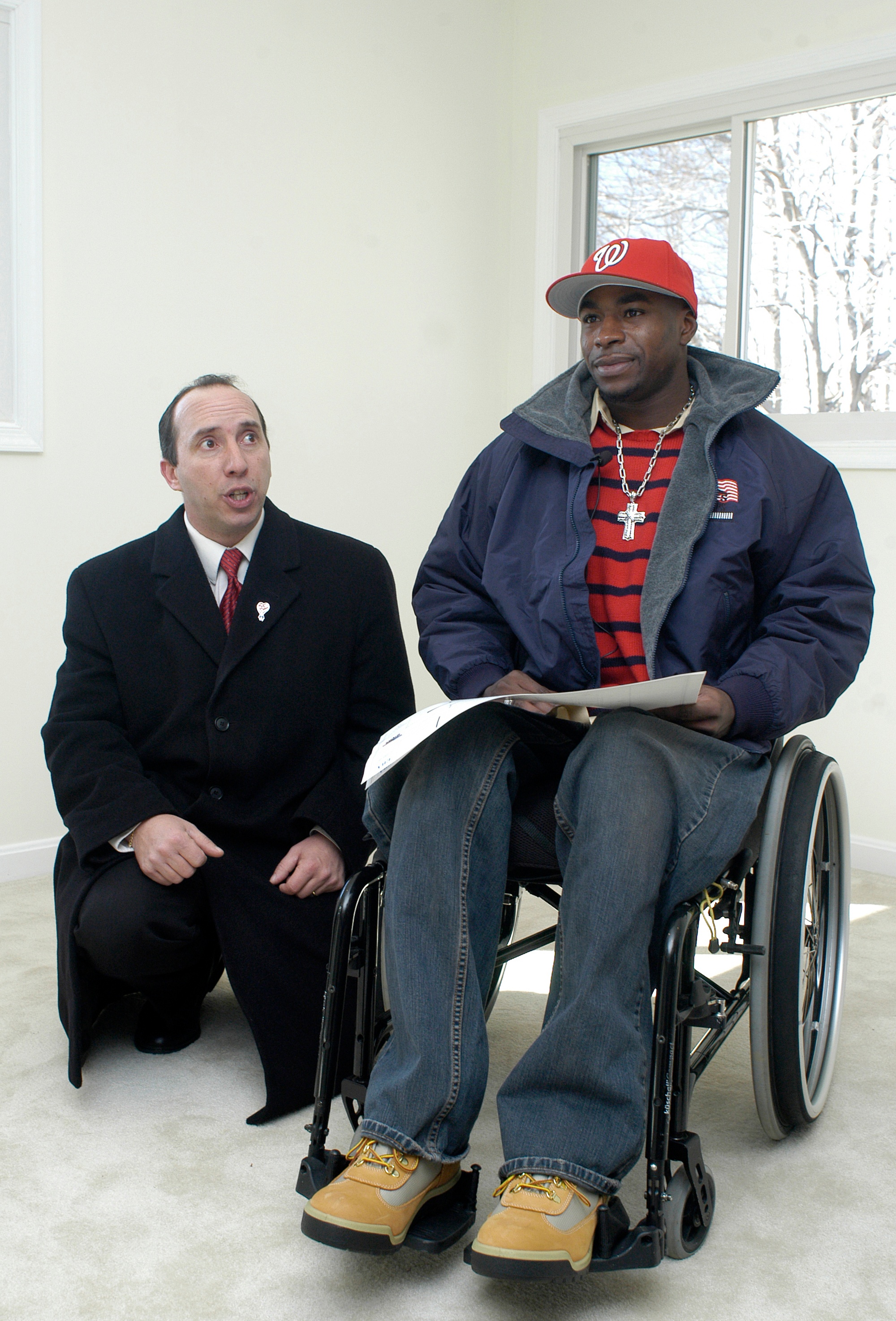 An Army veteran reviews home floor plans and paperwork during the unveiling of a recently purchased home.