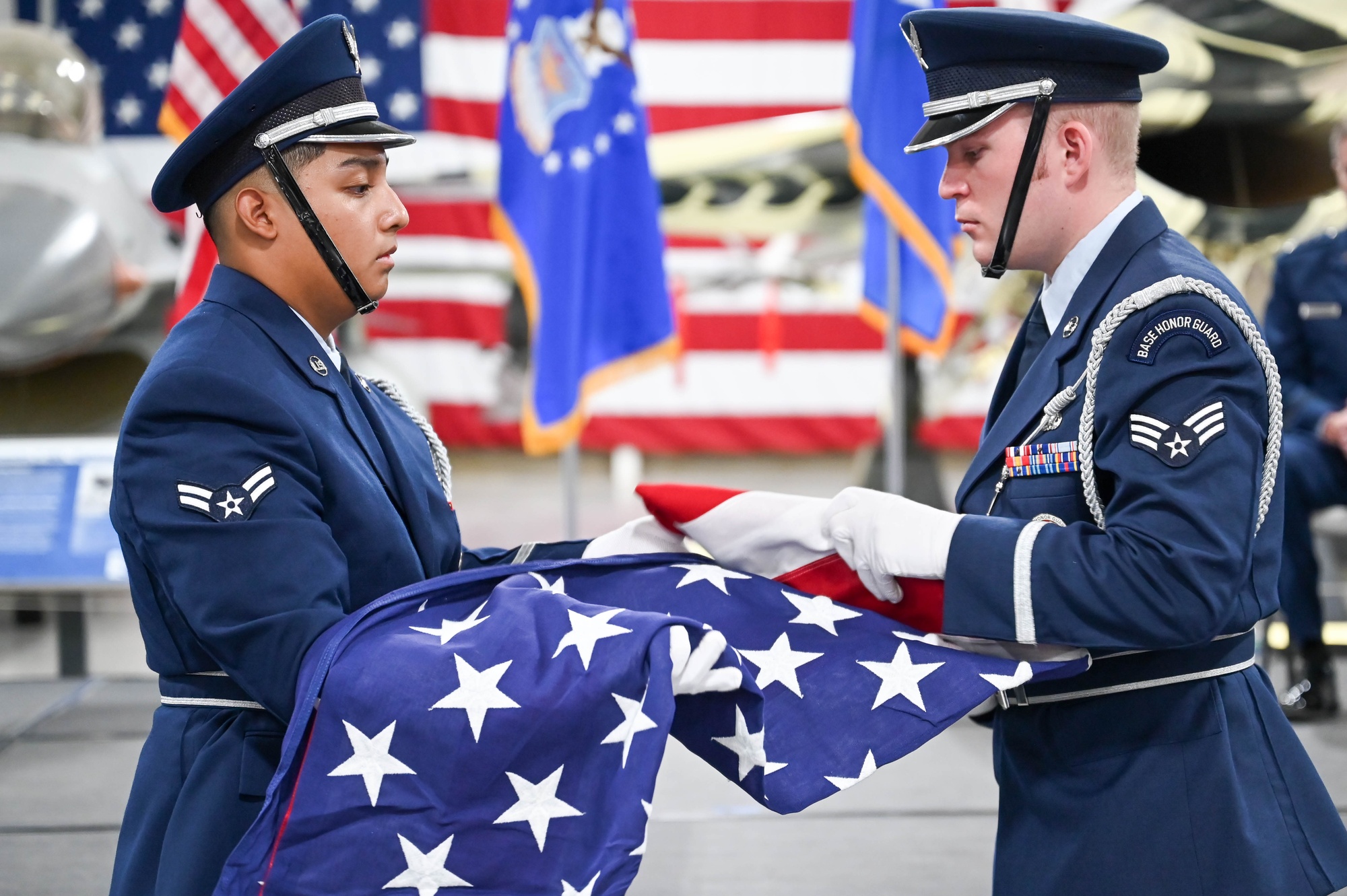 An American flag is folded during a ceremony