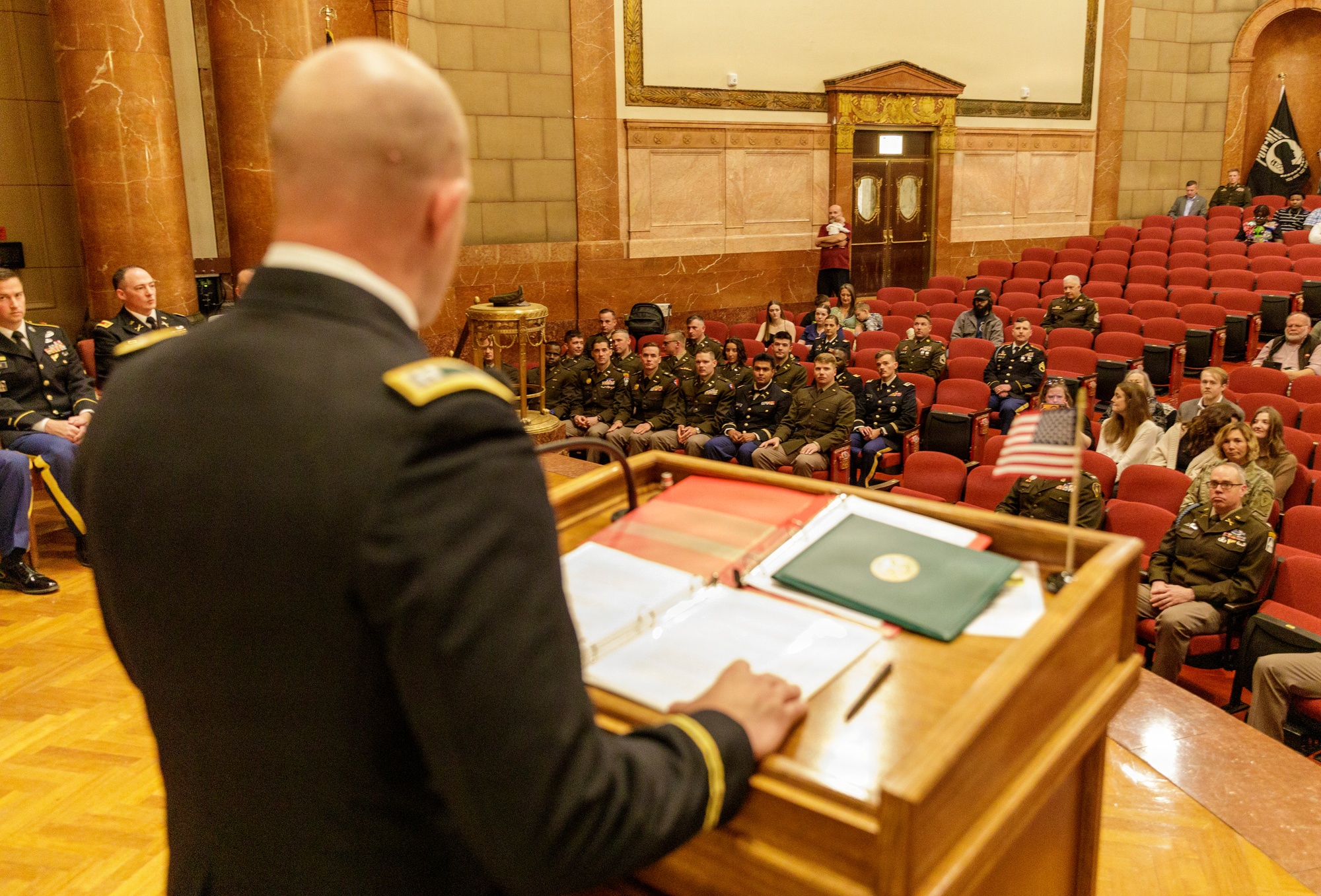 Graduates listen during an Officer Candidate School commencement