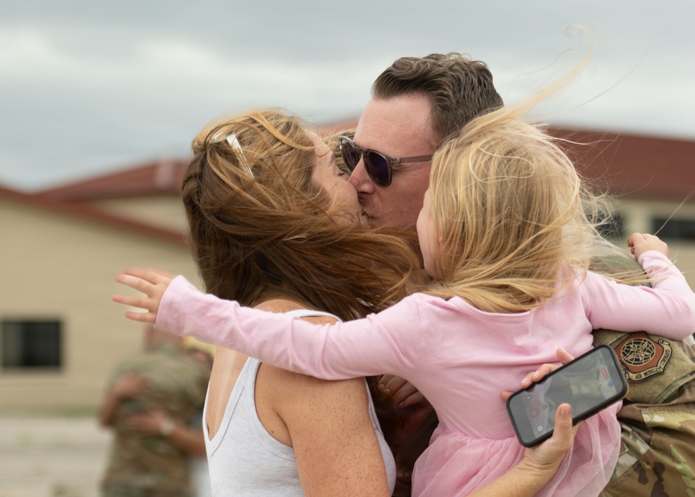 An airman reunites with his family after deployment at MacDill Air Force Base, Fla.