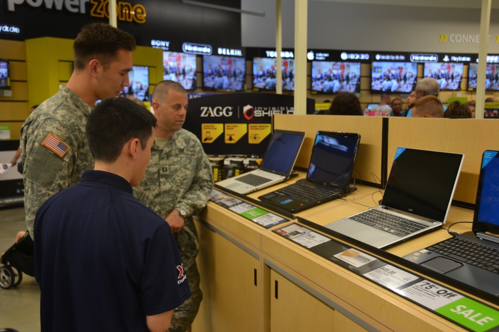 An Exchange associate assists two soldiers choosing a laptop at the Fort Belvoir, Va., main Exchange