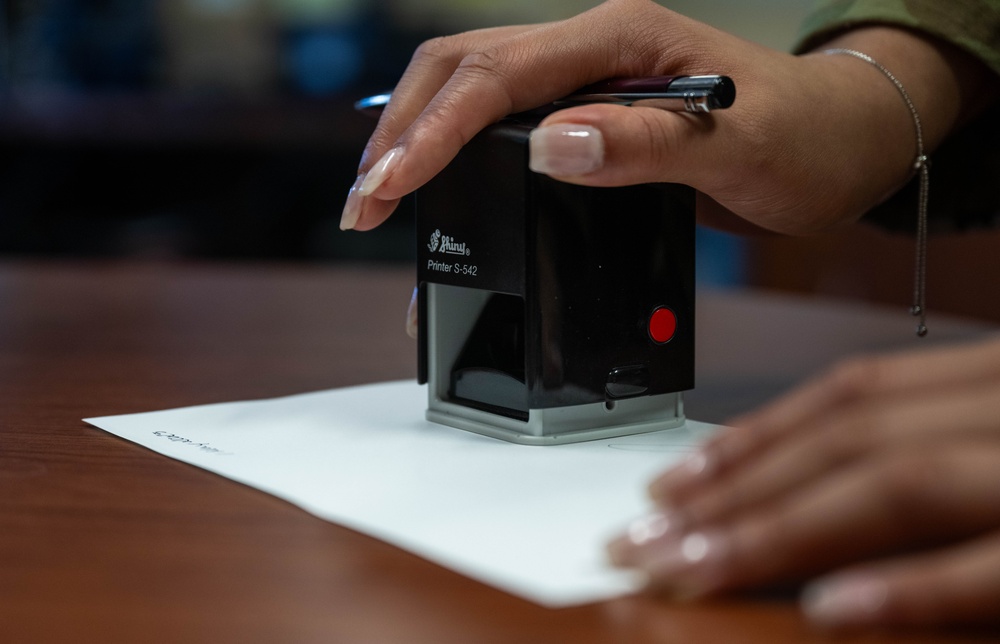 An Air Force paralegal notarizes a document for a service member during Legal Assistance Readiness Week at Joint Base Pearl Harbor-Hickam, Hawaii.