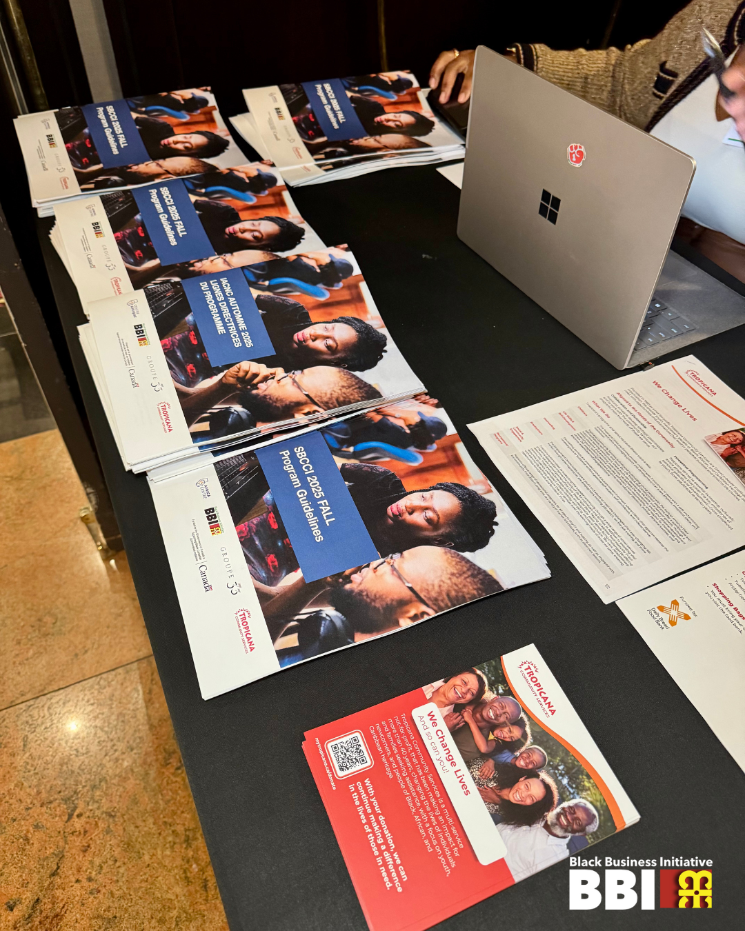 A table at a BBI containing multiple brochures at an information session