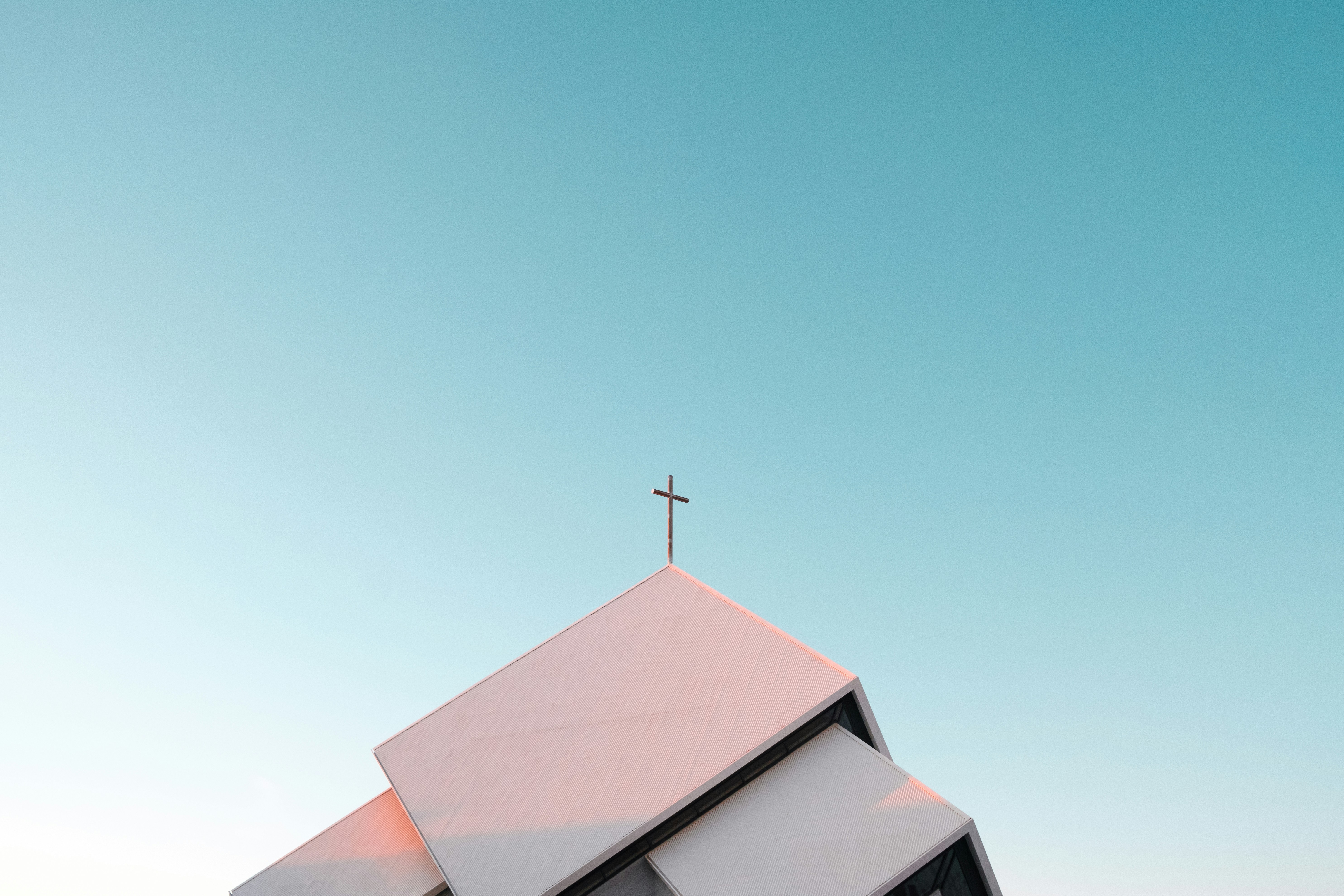top of a church building with the cross as the central focus