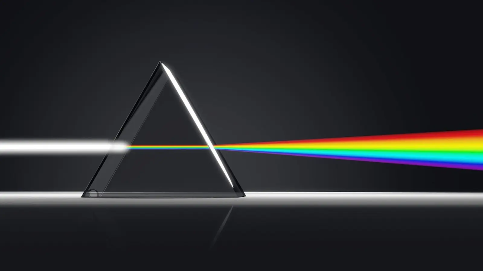 White light entering a prism and refracting out as a rainbow.