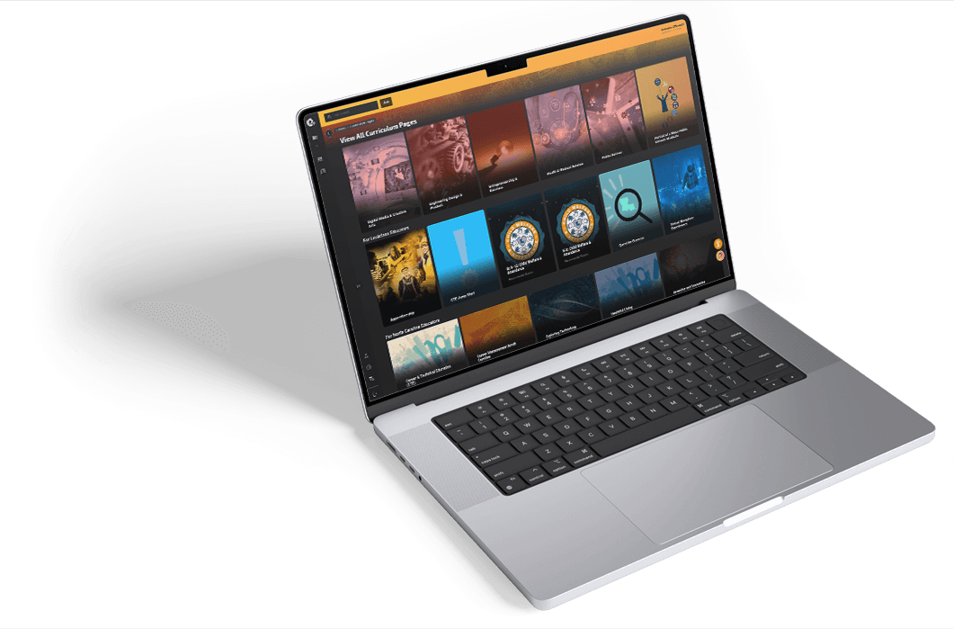 Open laptop displaying Edge Factor's digital curriculum interface with multiple course thumbnails and categories on screen.