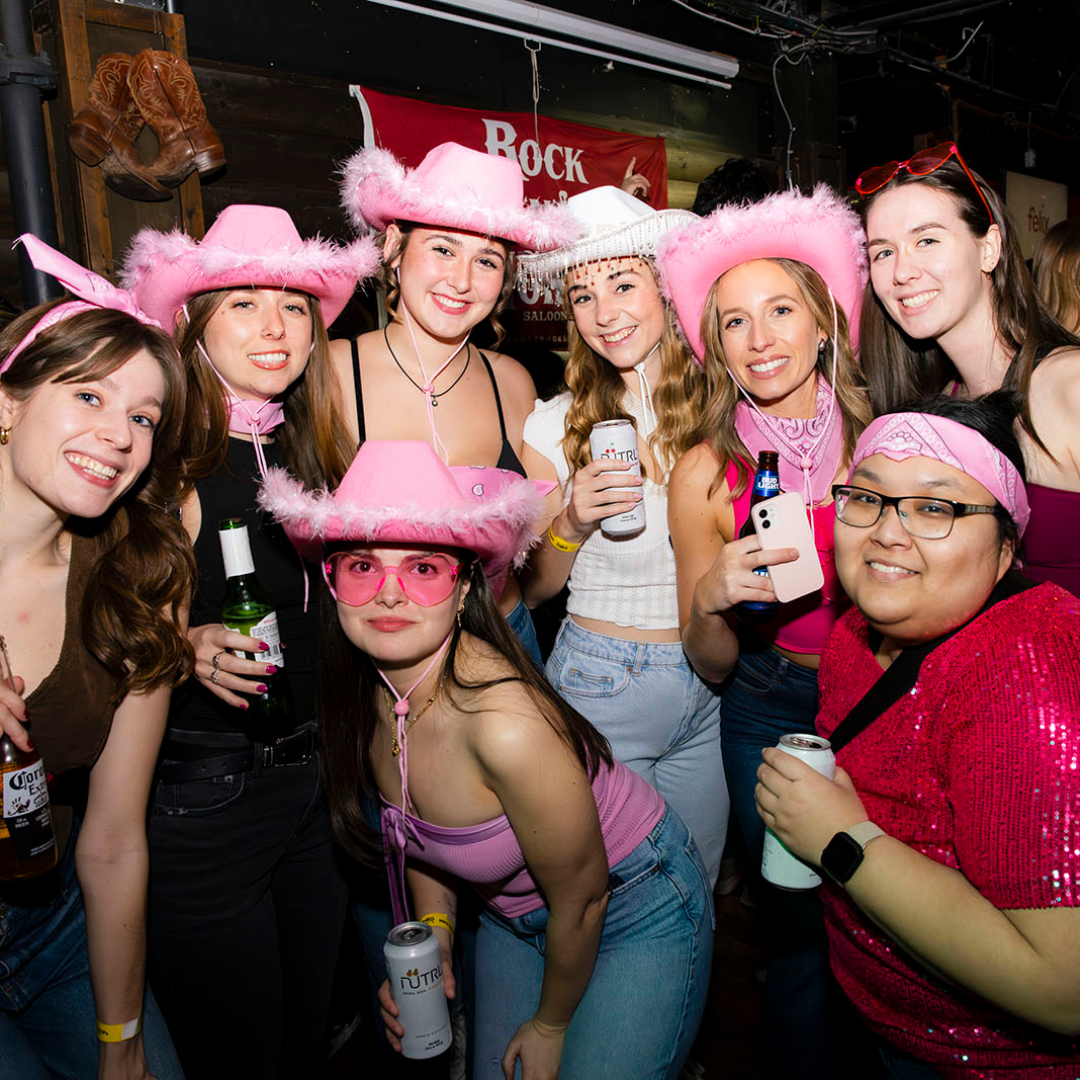 Bachelorette group wearing pink hats at a Toronto bar crawl event