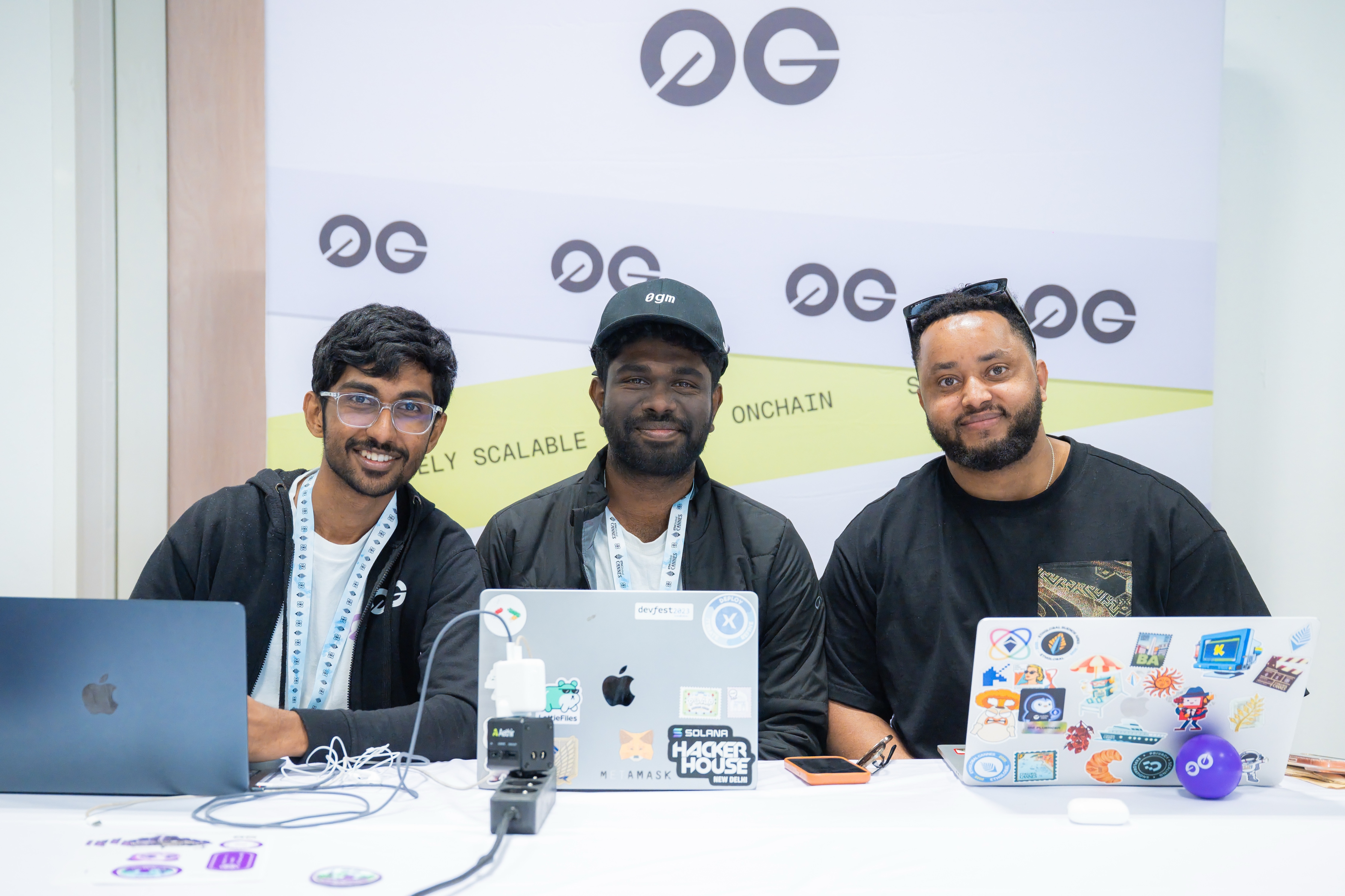0G team at ETHGlobal Cannes hackathon booth at Palais des Festivals