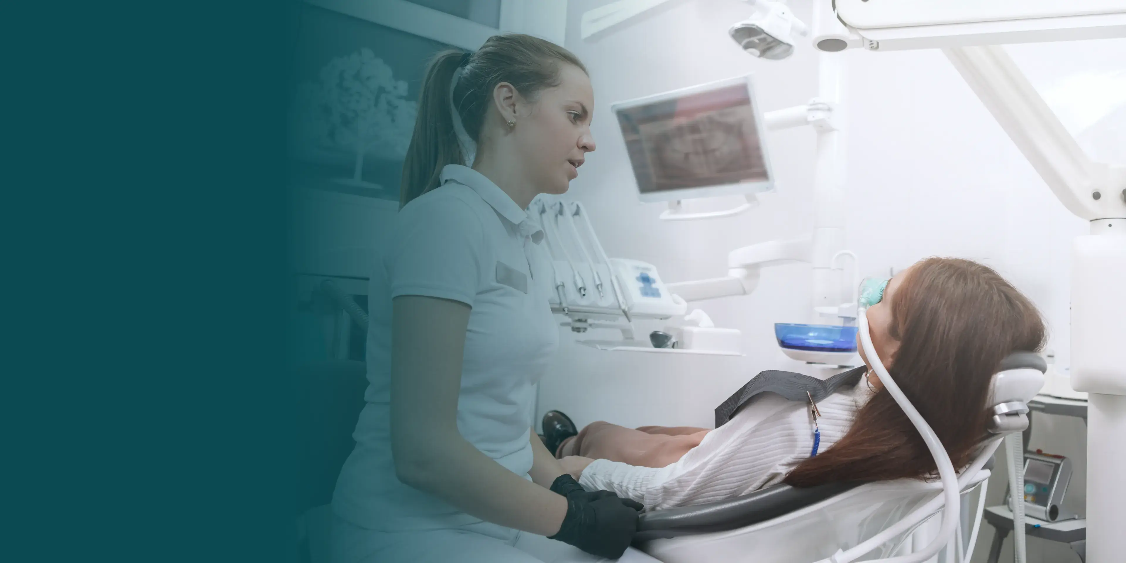 A dentist examines a patient sitting in a dental chair, focusing on her teeth.