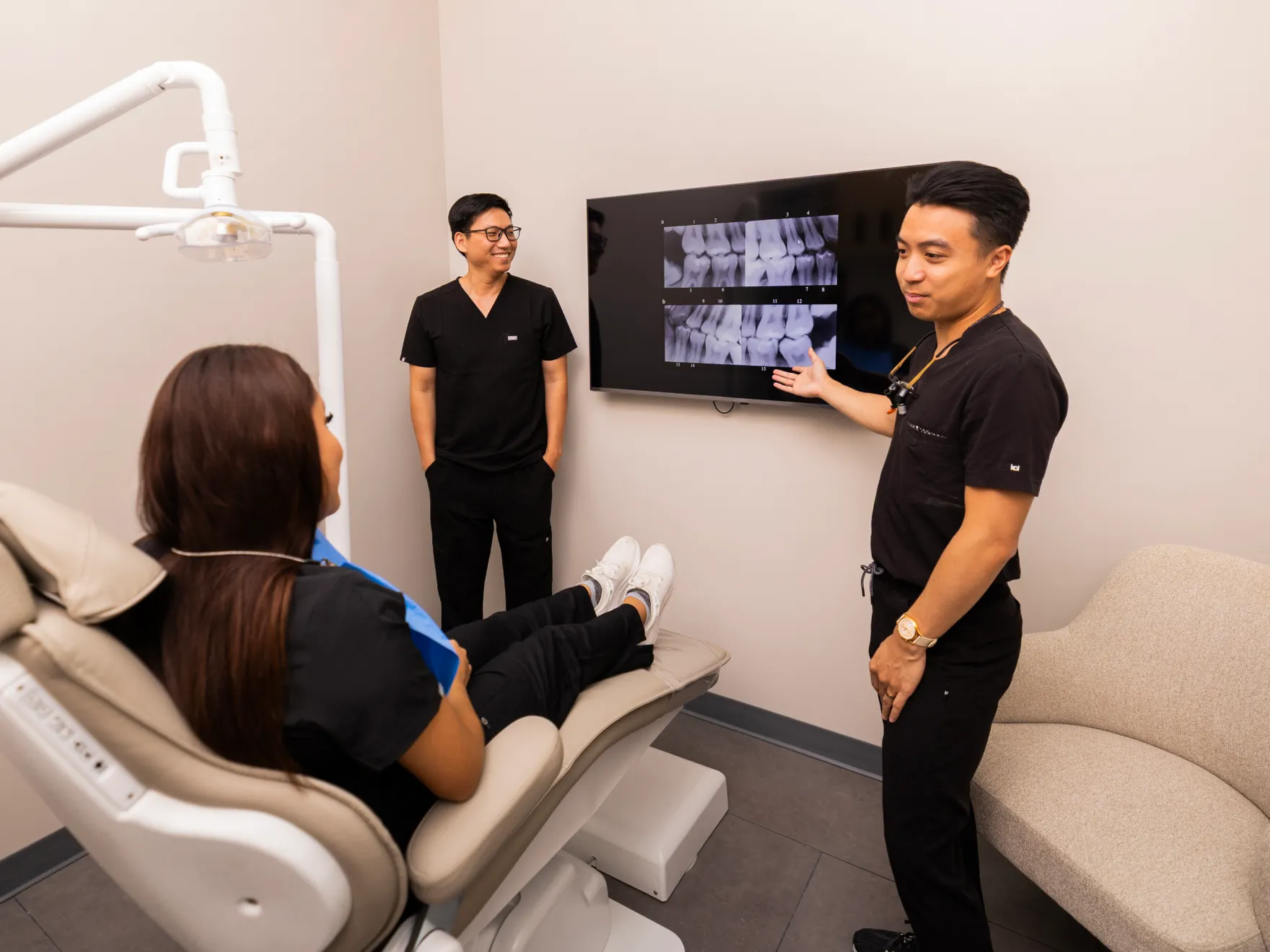 Dr. Bui and Dr. Huynh showing x-ray to patient