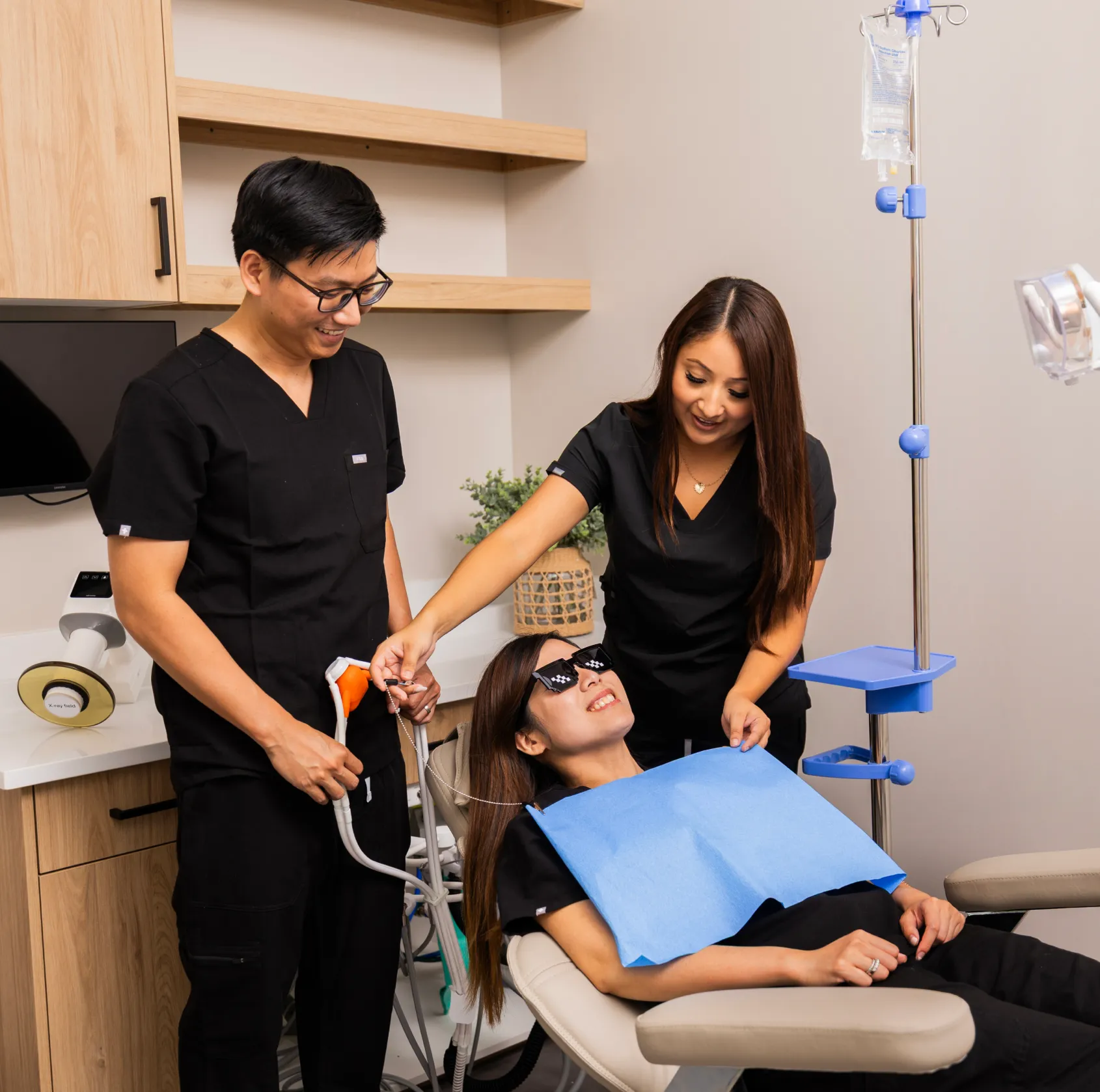 Dr. Huynh and team member adjusting patient's sedation mask