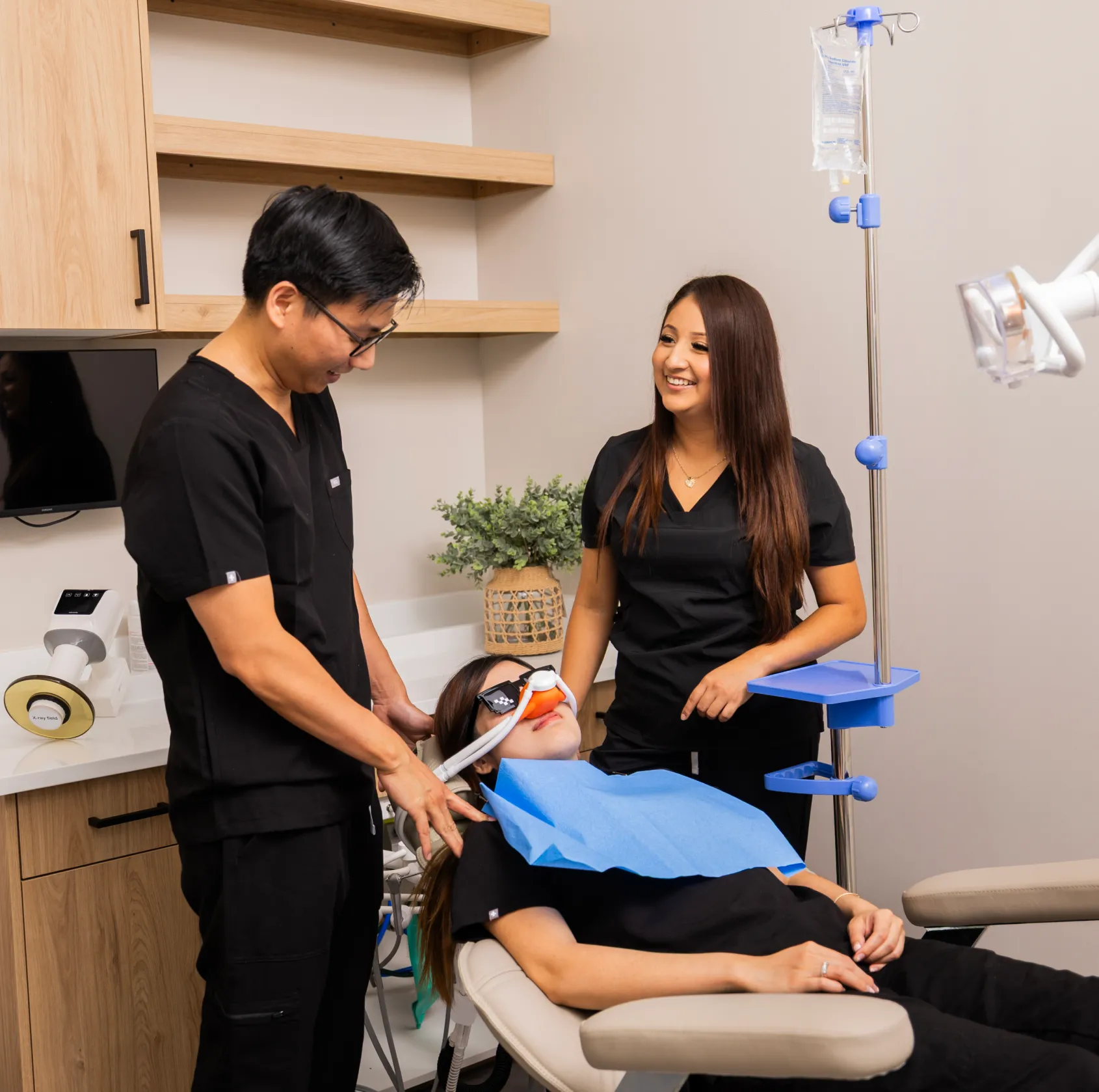 Dr. Huynh and Team Member adjusting patient's sedation mask
