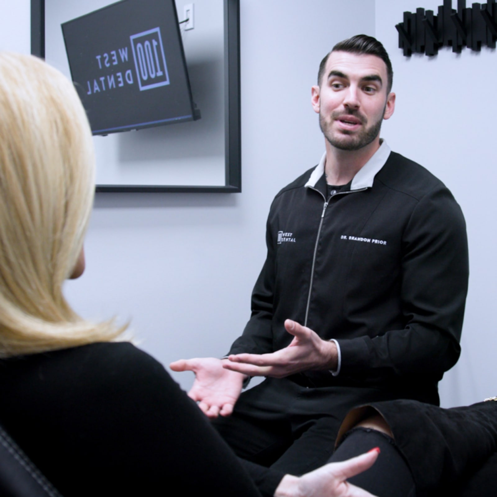 Dentist in consultation with patient discussing treatment options