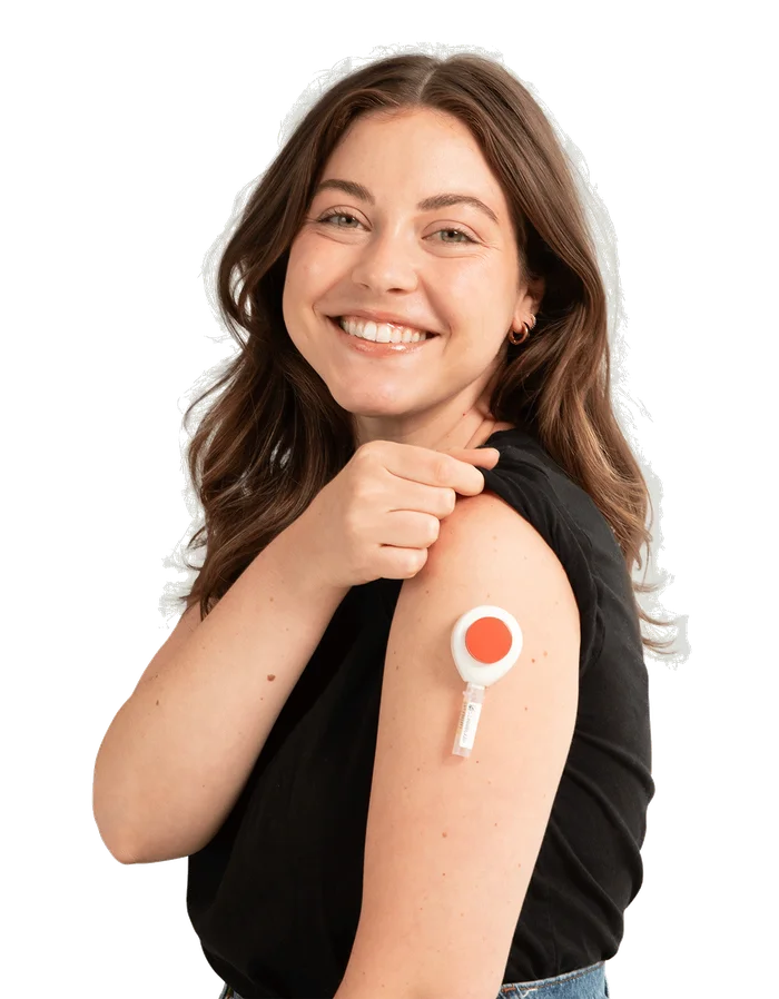 A customer shows a Tasso+ collection device on her upper arm