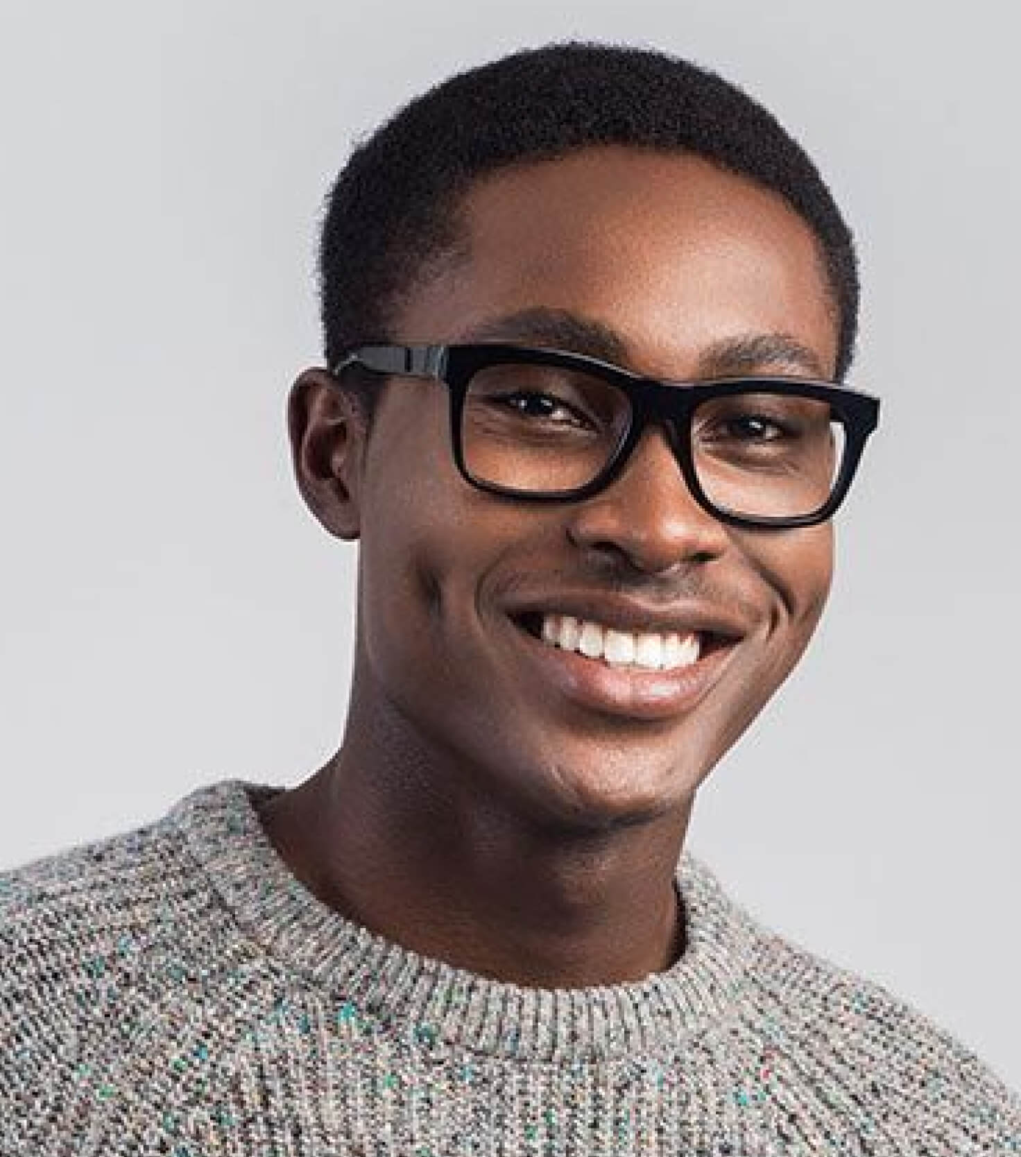 A man wearing glasses and smiling for the camera.