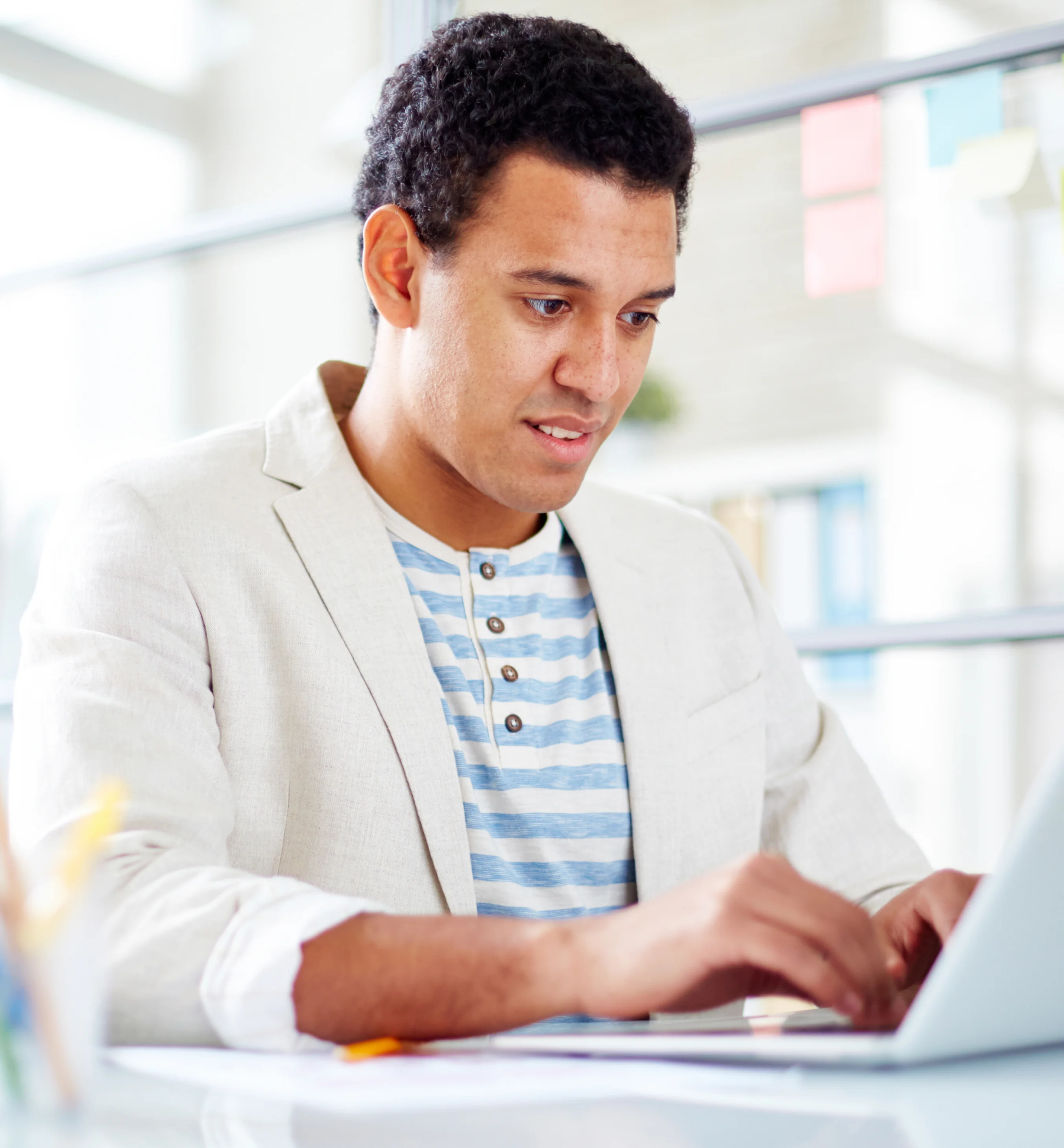 A man sitting in front of a laptop computer.