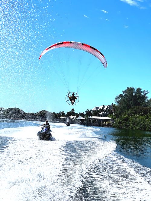 Guests paddle boarding on calm, crystal-clear waters at Clearwater Beach