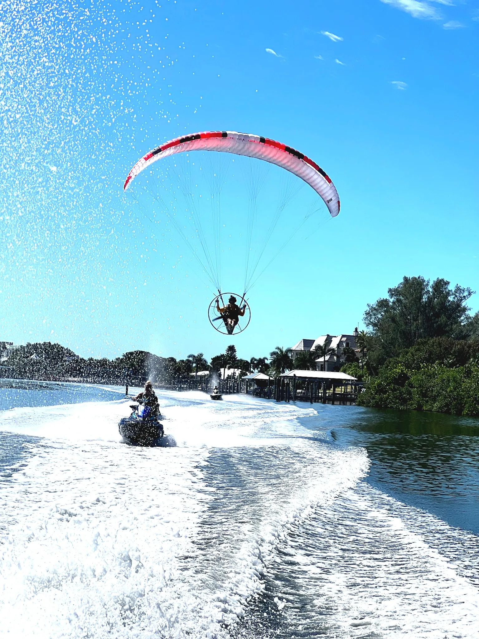 Guests paddle boarding on calm, crystal-clear waters at Clearwater Beach